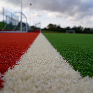 red turf, white lines, grass manufacturer, grass factory, synthetic, artificial, sports grass, sports turf production, sports turf manufacturing